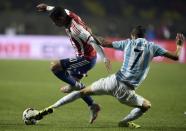 Paraguay's Derlis Gonzalez (L) fights for the ball with Argentina's Angel Di Maria during their Copa America semi-final match in Concepcion, Chile, on June 30, 2015