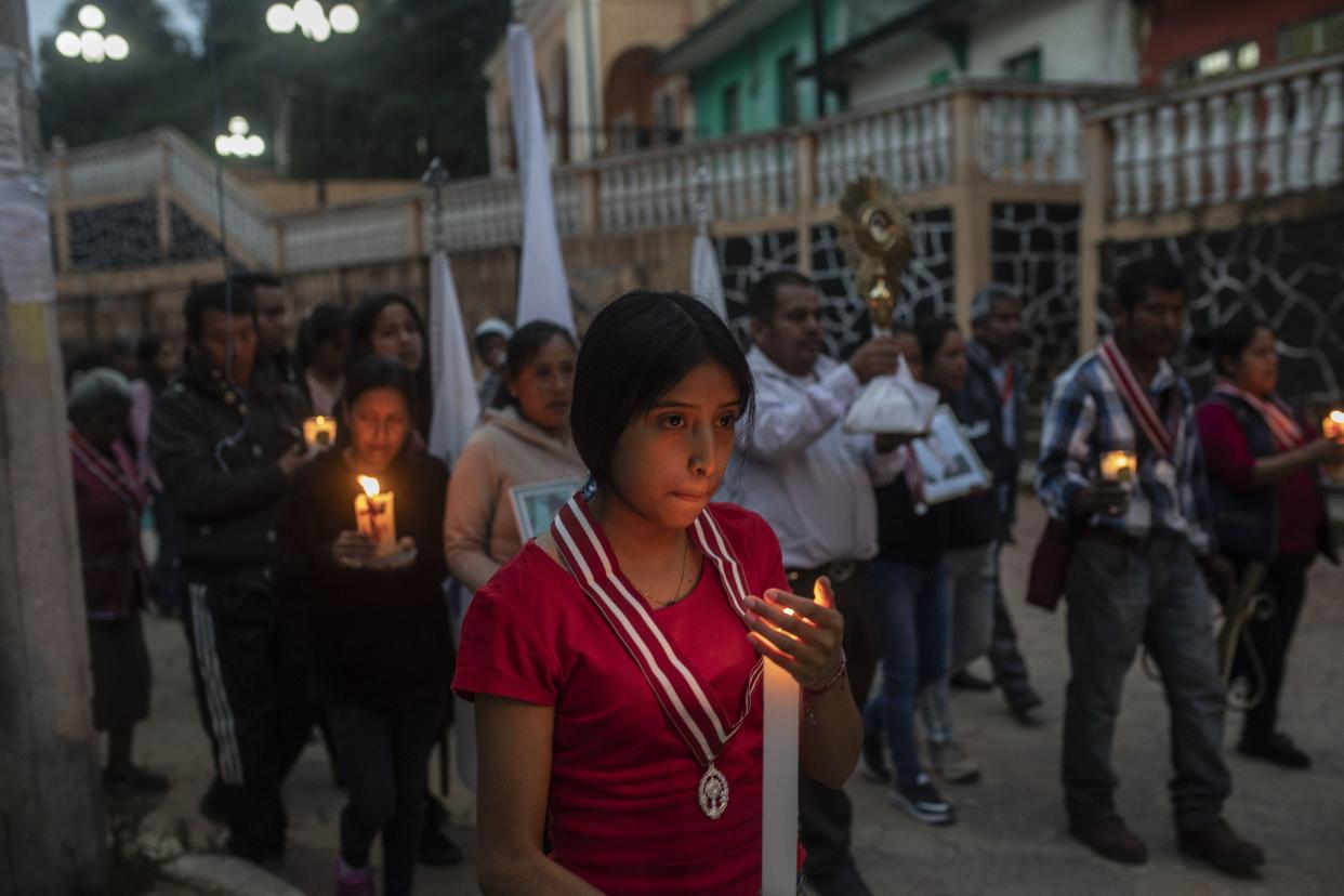 Residents hold a candlelight vigil to pray for three local teenagers in hopes they are not among the 53 migrants who died in a stifling, abandoned trailer in Texas, in San Marcos Atexquilapan, Veracruz state, Mexico, late Thursday, June 30, 2022.