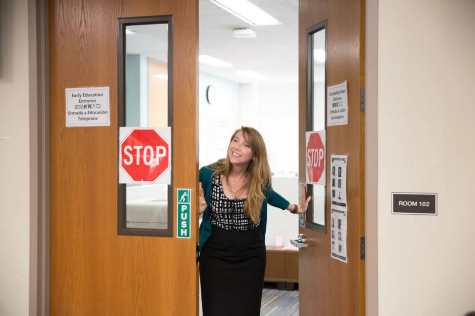 Lauren Koehler, executive director of San Francisco Unified School District’s Enrollment Center, invites a family from the waiting room to a counseling session in a sunny conference room two days before the start of the 2023-24 school year. (Sonya Abrams)