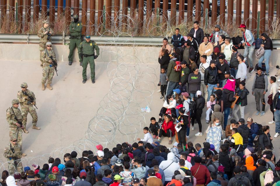 Migrants crossed the Rio Grande and approach the Texas National Guard to enquire when they will be allowed to be processed by Customs and Border Protection to seek asylum in El Paso, Texas on Dec. 20, 2022 