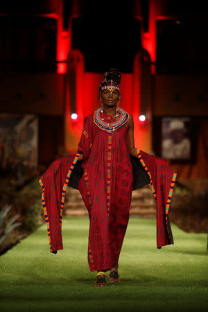 A model walks on a catwalk during a fashion show featuring African fashion and culture as part of a gala marking the launch of a book called "African Twilight: The Vanishing Rituals and Ceremonies of the African Continent" at the African Heritage House in Nairobi, Kenya March 3, 2019. REUTERS/Baz Ratner