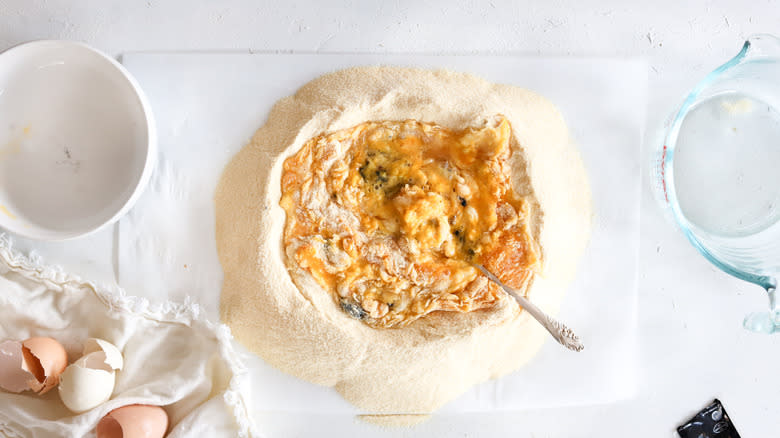 semolina mixed with eggs on a cutting board