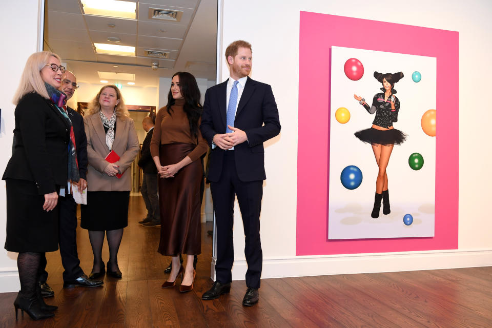 LONDON, UNITED KINGDOM - JANUARY 07: Prince Harry, Duke of Sussex and Meghan, Duchess of Sussex stand with High Commissioner for Canada in the United Kingdom, Janice Charette (C) as they view a special exhibition of art by Indigenous Canadian artist, Skawennati, in the Canada Gallery during their visit to Canada House in thanks for the warm Canadian hospitality and support they received during their recent stay in Canada, on January 7, 2020 in London, England. (Photo by DANIEL LEAL-OLIVAS  - WPA Pool/Getty Images)