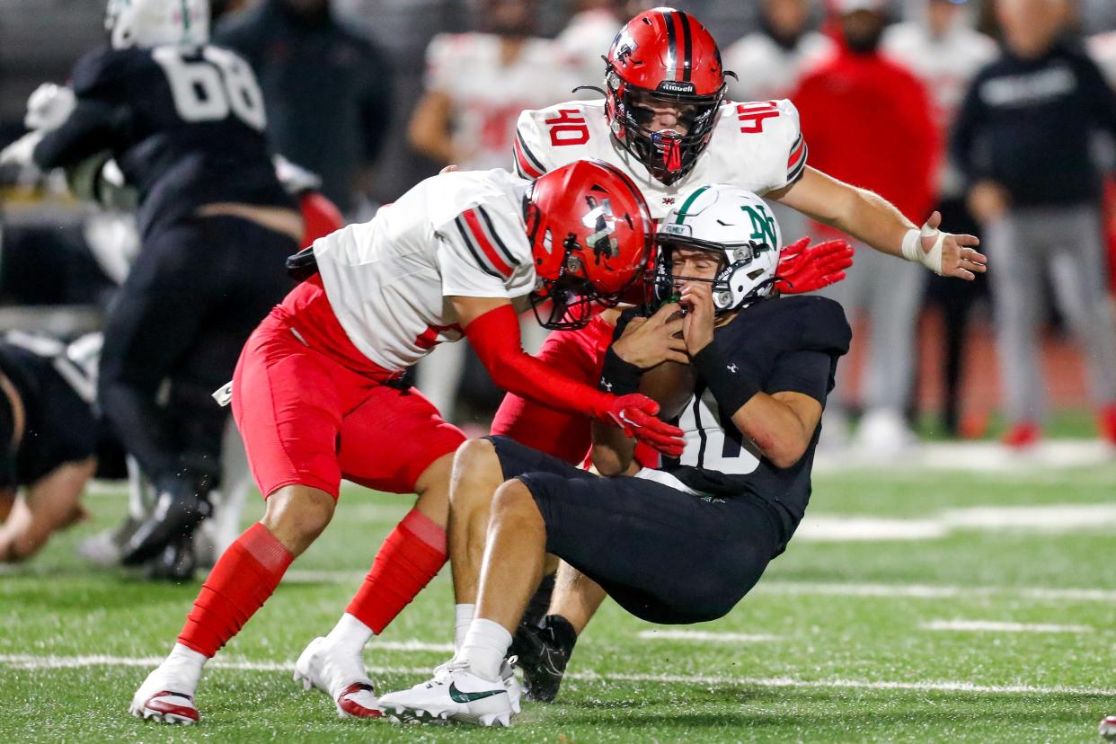 Norman North’s Owen Eshelman (10) is taken down by Westmoore’s Connor Cavnar (40) and Jaden Williams (6) during a high school football game between Norman North and Westmoore in Norman Okla., on Friday, Oct. 27, 2023.