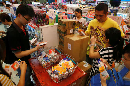 People shop for remaining stocks of insect repellent products at a pharmacy in Singapore September 2, 2016. REUTERS/Edgar Su