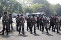 Armed police with shield stand in formation during a demonstration against the military coup in Yangon, Myanmar, Friday, Feb. 26, 2021. Security forces in Myanmar's largest city on Friday fired warning shots and beat truncheons against their shields while moving to disperse more than 1,000 anti-coup protesters. (AP Photo)