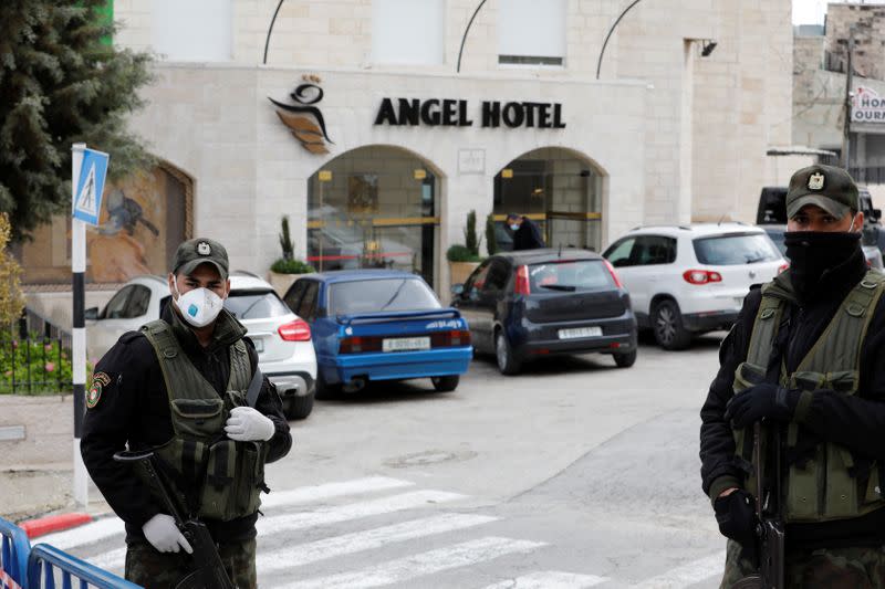 Members of Palestinian security forces stand guard outside Angel Hotel in Beit Jala town in the Israeli-occupied West Bank