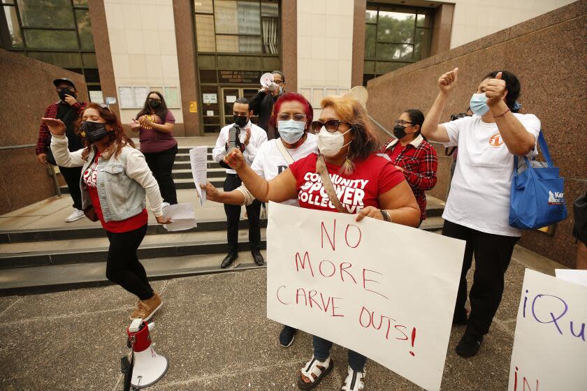 LOS ANGELES, CA - SEPTEMBER 27: Eva Garcia, Georgina Serrano, Fanny Ortiz and Alicia Godinez, left to right, dance as they join other tenants and advocates who kicked off a week of action with a rally outside the Kenneth Hahn Hall of Administration to demand the LA County Board of Supervisors extend eviction protections without any additional carve outs that could result in thousands of evictions. The Board is scheduled to vote on extending eviction protections on Tuesday, September 28th and they are urging the LA County Board of Supervisors to extend COVID-19 Tenant Protections through January 2022. Kenneth Hahn Hall of Administration on Monday, Sept. 27, 2021 in Los Angeles, CA. (Al Seib / Los Angeles Times).