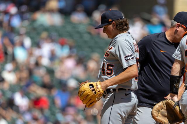 Detroit Tigers' Spencer Torkelson, left, smiles after he and Riley Greene,  back right, scored on a three-run home run by Kerry Carpenter (30), while  Seattle Mariners catcher Cal Raleigh waits during the