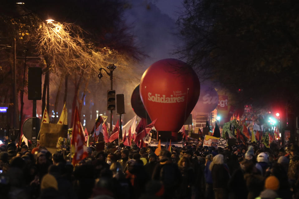 People march during a demonstration in Paris, Thursday, Dec. 5, 2019. The Eiffel Tower shut down, France's high-speed trains stood still and tens of thousands of people marched through Paris and other cities Thursday, in a massive and sometimes chaotic outpouring of anger at the government's plan to overhaul the retirement system. (AP Photo/Thibault Camus)