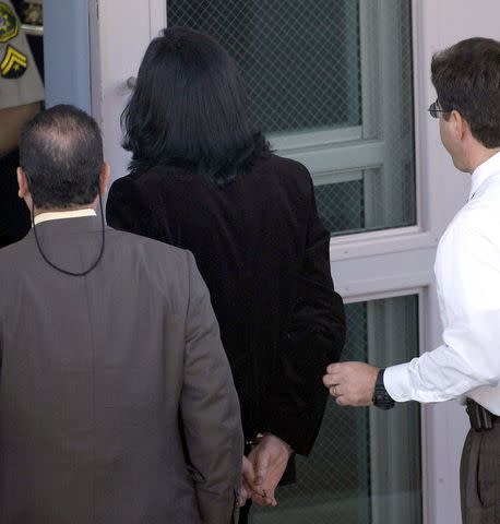 <p>Nick Ut-Pool/Getty</p> Michael Jackson taken into custody in November 2003