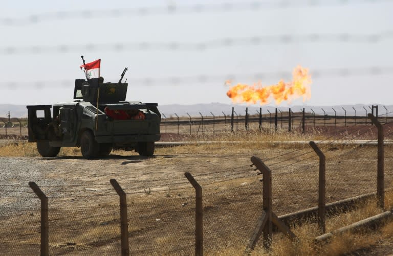 An Iraqi army vehicle stands guard at the Bai Hassan oil field, west of Kirkuk, on October 17, 2017, one of a string retaken from the Kurds this month in a crippling blow to their finances