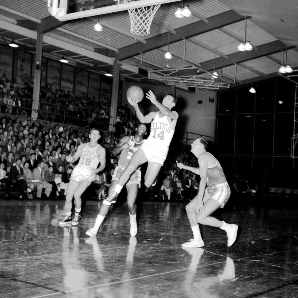 Bob Cousy of the Boston Celtics drives to the basket against the Los Angeles Lakers in a game played at Rogers High School in Newport.