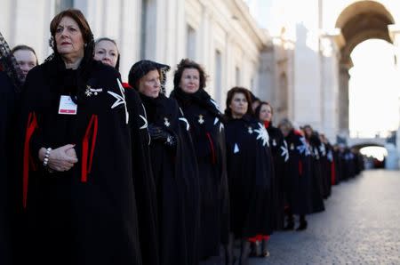 Members of the Order of the Knights of Malta arrive in St. Peter Basilica for their 900th anniversary at the Vatican February 9, 2013. REUTERS/Alessandro Bianchi/File Photo