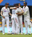 India's Mohammed Siraj, centre, celebrates with teammate Mayank Agarwal, second left, after taking his fifth wicket during play on day four of the fourth cricket test between India and Australia at the Gabba, Brisbane, Australia, Monday, Jan. 18, 2021. (AP Photo/Tertius Pickard)