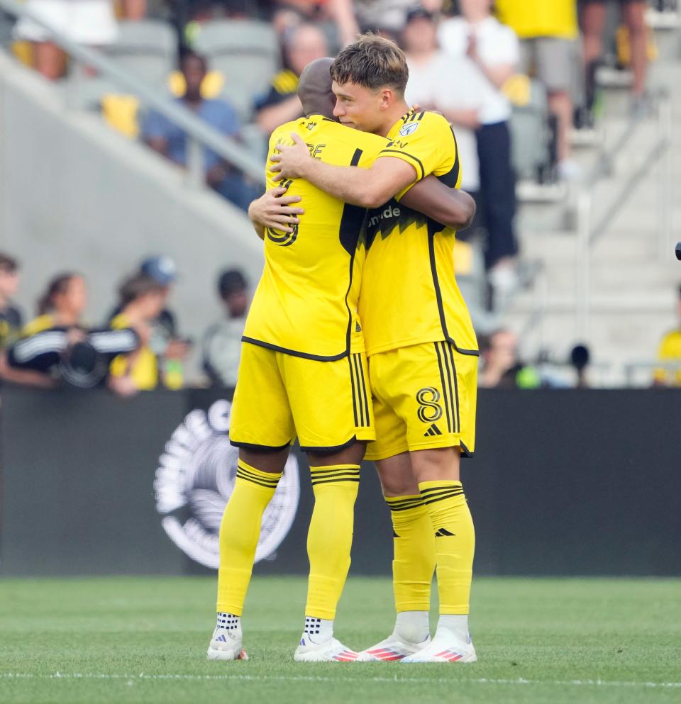 Jun 22, 2024; Columbus, OH, USA; Columbus Crew midfielder Aidan Morris (8) hugs Columbus Crew midfielder Darlington Nagbe (6) before the start of their MLS game against Sporting KC at Lower.com Field.