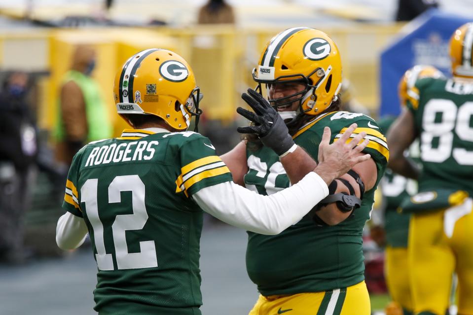 Green Bay Packers' Aaron Rodgers celebrates his touchdown run with David Bakhtiari during the first half of an NFL football game against the Jacksonville Jaguars Sunday, Nov. 15, 2020, in Green Bay, Wis. (AP Photo/Matt Ludtke)