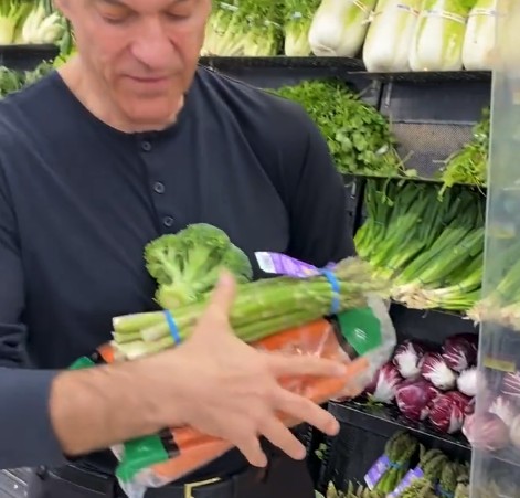 Oz holding various vegetables