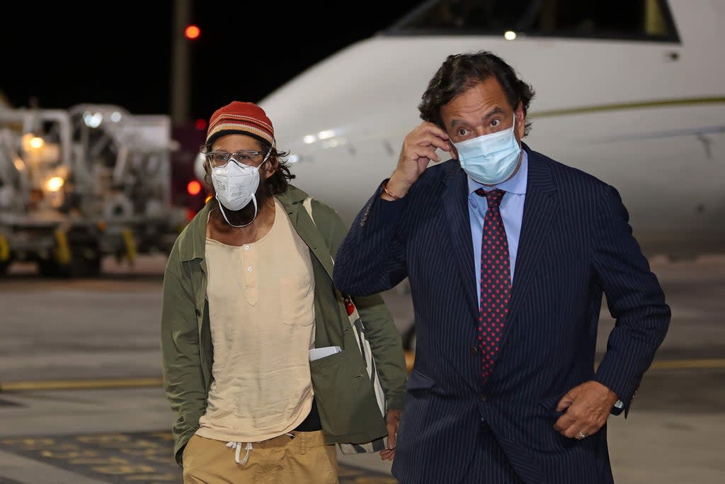 US journalist Danny Fenster and diplomat Bill Richardson leave a plane in Doha, Qatar (AFP via Getty Images)