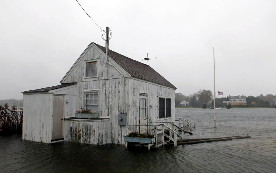 A house is inundated by flood water as Hurricane Sandy approaches, Monday, Oct. 29, 2012, in Center Moriches, N.Y. Many homeowners who suffered losses because of flooding from Hurricane Sandy are likely to find themselves out of luck. Standard homeowners policies don't cover flooding damage, and the vast majority of homeowners don't have flood insurance. Yet it's likely that many Northeasterners will purchase it in coming months, hoping they'll be covered the next time around, at a cost averaging around $600 a year. (AP Photo/Jason DeCrow)