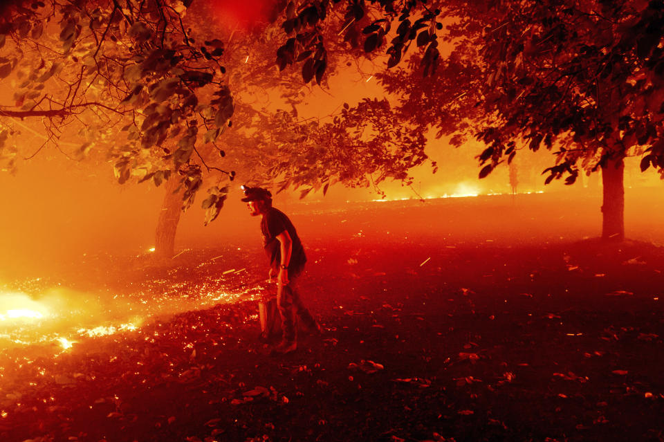 California resident Matt Nichols tries to save his home as the LNU Lightning Complex fires tear through Vacaville on Wednesday. (Photo: ASSOCIATED PRESS)