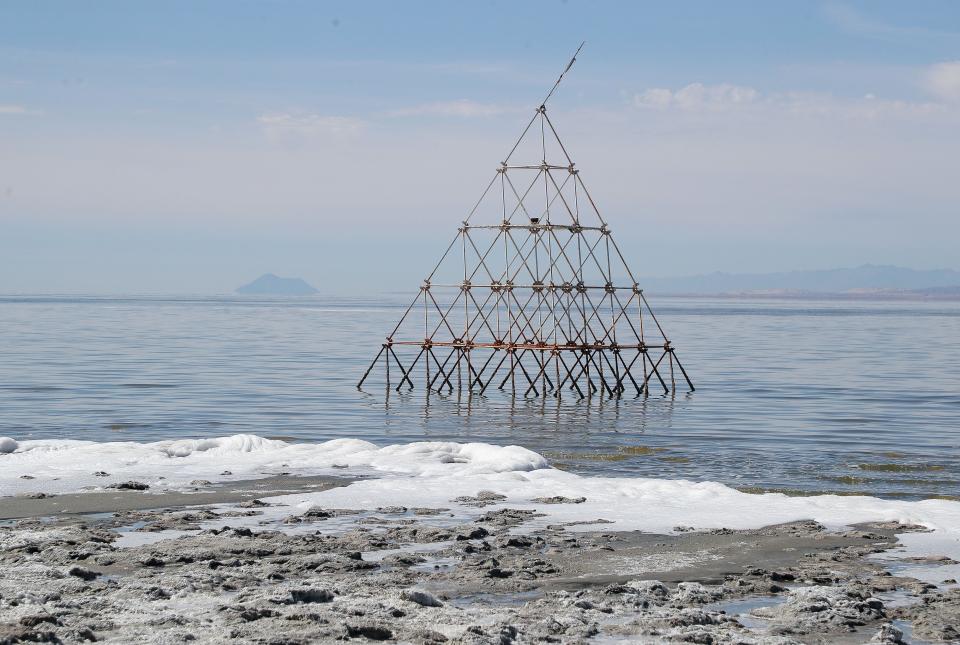 A sculpture sits just off the shoreline of the Salton Sea during the Bombay Beach Biennale in Bombay Beach, Calif., March 31, 2023. 