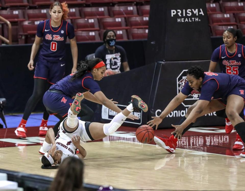 South Carolina Gamecocks guard Zia Cooke (1) falls as Ole Miss guard Donnetta Johnson (3) and forward Iyanla Kitchens (32) go for a loose ball during the first half of action in the Colonial Life Arena in Columbia, S.C.