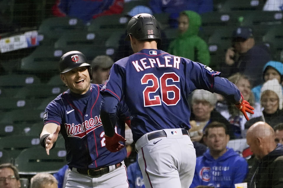 Minnesota Twins' Josh Donaldson, left, congratulates Max Kepler after Kepler's two-run home run off Chicago Cubs starting pitcher Kyle Hendricks during the first inning of a baseball game Wednesday, Sept. 22, 2021, in Chicago. (AP Photo/Charles Rex Arbogast)