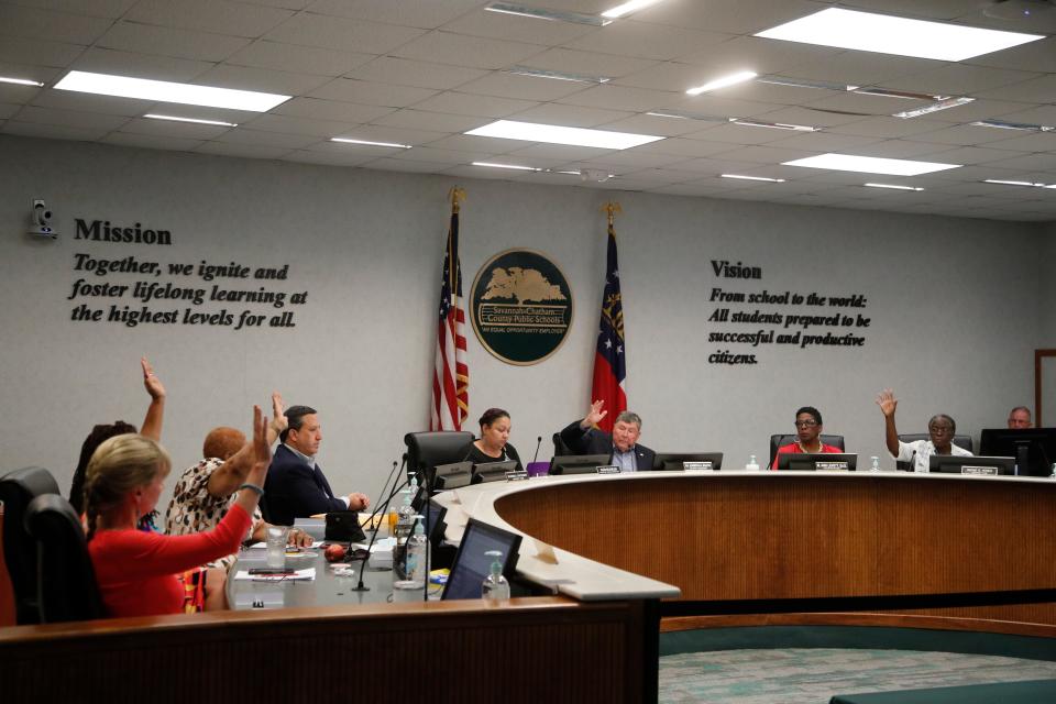 Members of the school board vote for the 2023 Savannah Chatham County Public Schools budget Wednesday evening during a special meeting. The proposed budget passed by a vote of 7-2.