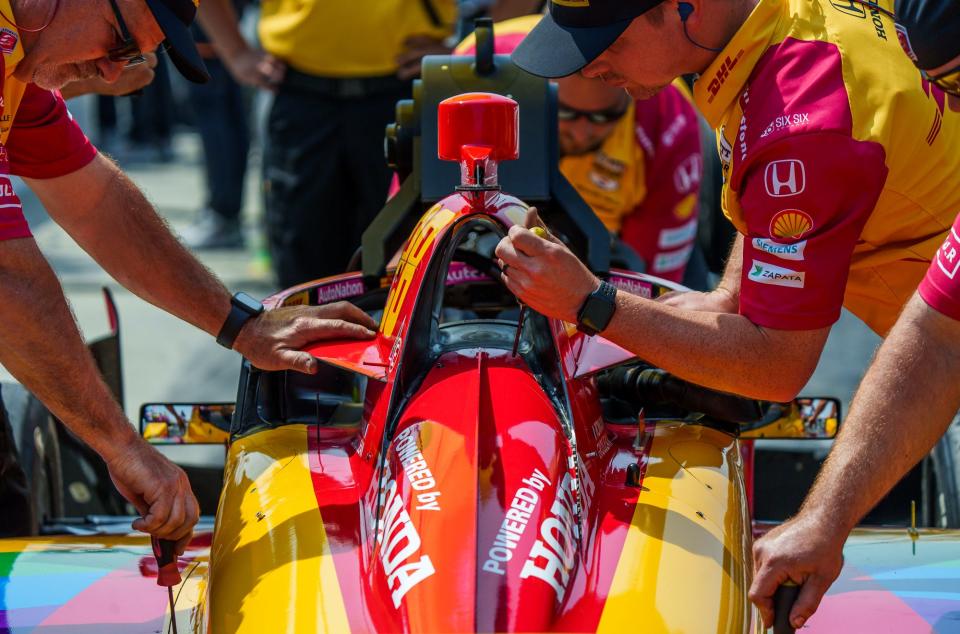 Crew for Andretti Autosport driver Romain Grosjean (28) make adjustments on the car Friday, May 19, 2023, during Fast Friday practice at Indianapolis Motor Speedway in preparation for the 107th running of the Indianapolis 500.