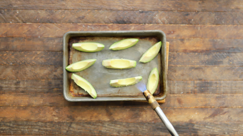 Torch charring avocado slices