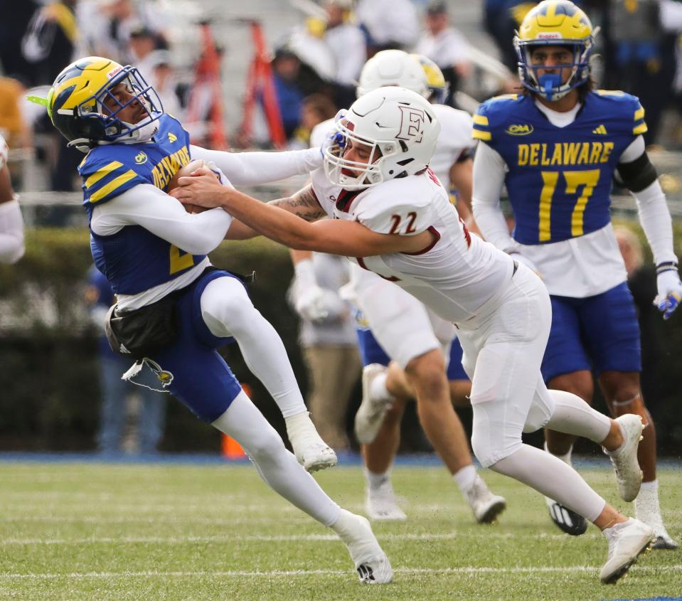 Delaware returner JoJo Bermudez loses the opening kickoff to Elon kicker Jake Merion, who stripped the ball and forced a fumble recovered by the Phoenix at Delaware Stadium, Saturday, Nov. 4, 2023. Elon converted the turnover into a field goal to take an early lead.