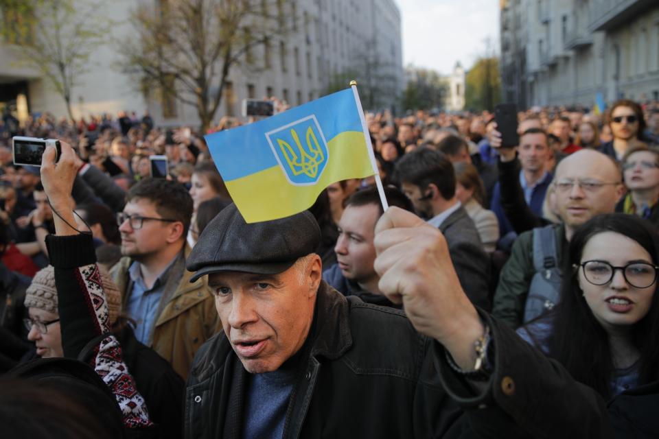 Supporters of Ukrainian President Petro Poroshenko, who have come to thank him for what he did as a president, listen to his speech in Kiev, Ukraine, Monday, April 22, 2019. Political mandates don't get much more powerful than the one Ukrainian voters gave comedian Volodymyr Zelenskiy, who as president-elect faces daunting challenges along with an overwhelming directive to produce change. (AP Photo/Vadim Ghirda)