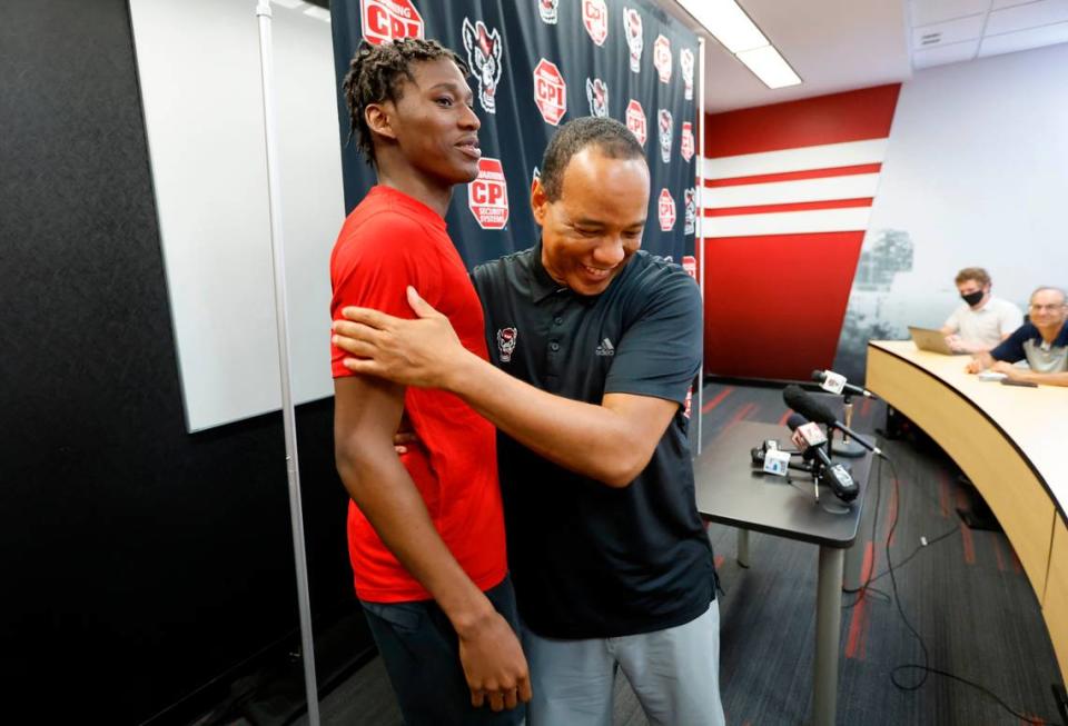 N.C. State coach Kevin Keatts hugs Terquavion Smith after Keatts finished talking with the media in Raleigh, N.C., Wednesday, June 15, 2022.