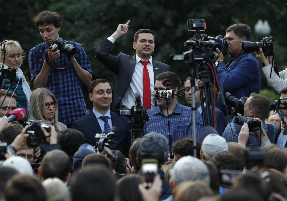 Russian opposition candidate Russian and activist Ilya Yashin, center, gestures while speaking to a crowd during a protest in Moscow, Russia, Monday, July 15, 2019. Opposition candidates who run for seats in the city legislature in September's elections have complained that authorities try to bar them from the race by questioning the validity of signatures of city residents they must collect in order to qualify for the race. (AP Photo/Pavel Golovkin)