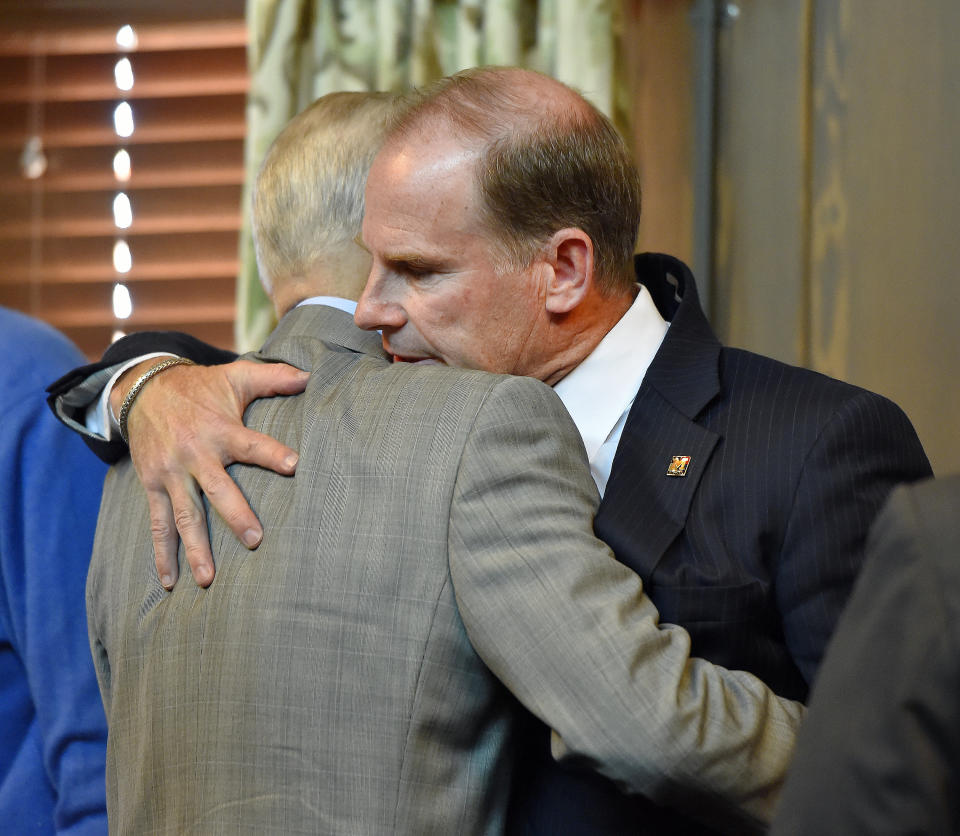 University of Missouri system President Tim Wolfe, right, is hugged by board of curators member Maurice Graham after Wolfe resigned on Monday, Nov. 9, 2015, in Columbia, Mo., under pressure from student protesters who claimed he had not done enough to address recent racially-motivated incidents on the Columbia campus. (Allison Long/Kansas City Star/TNS via Getty Images)