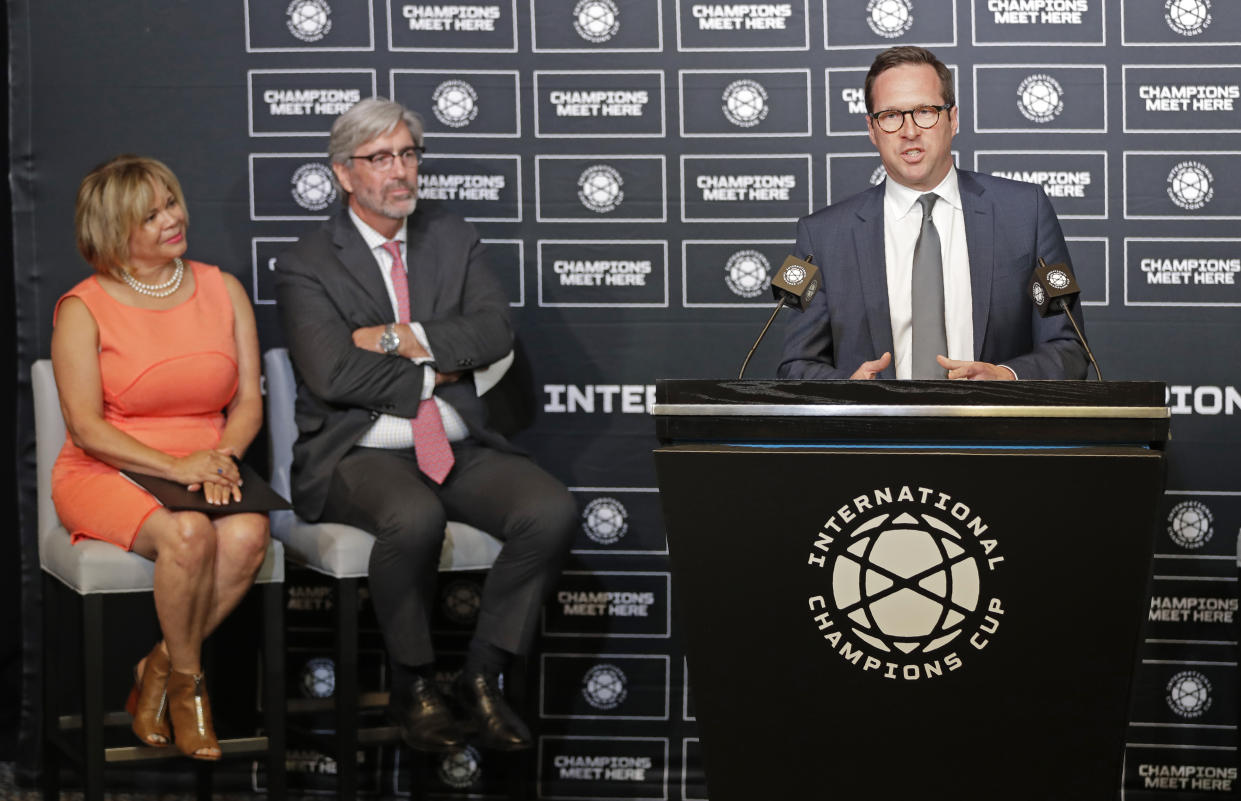 Carolina Panthers president Tom Glick, right, speaks to the media as Charlotte, N.C., mayor Vi Lyles, left, and Charlotte Regional Visitors Authority CEO Tom Murray, center, listen during a news conference in Charlotte, N.C., Tuesday, July 9, 2019. Glick and Carolina Panthers owner David Tepper will travel to New York to meet with Major League Soccer officials in hopes of bringing an expansion team to Charlotte. (AP Photo/Chuck Burton)