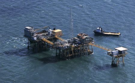 Rescue crew surrounds an oil platform operated by Houston-based Black Elk Energy which exploded off the coast of Louisiana in the Gulf of Mexico, in this November 16, 2012 file photo. REUTERS/Sean Gardner/Files