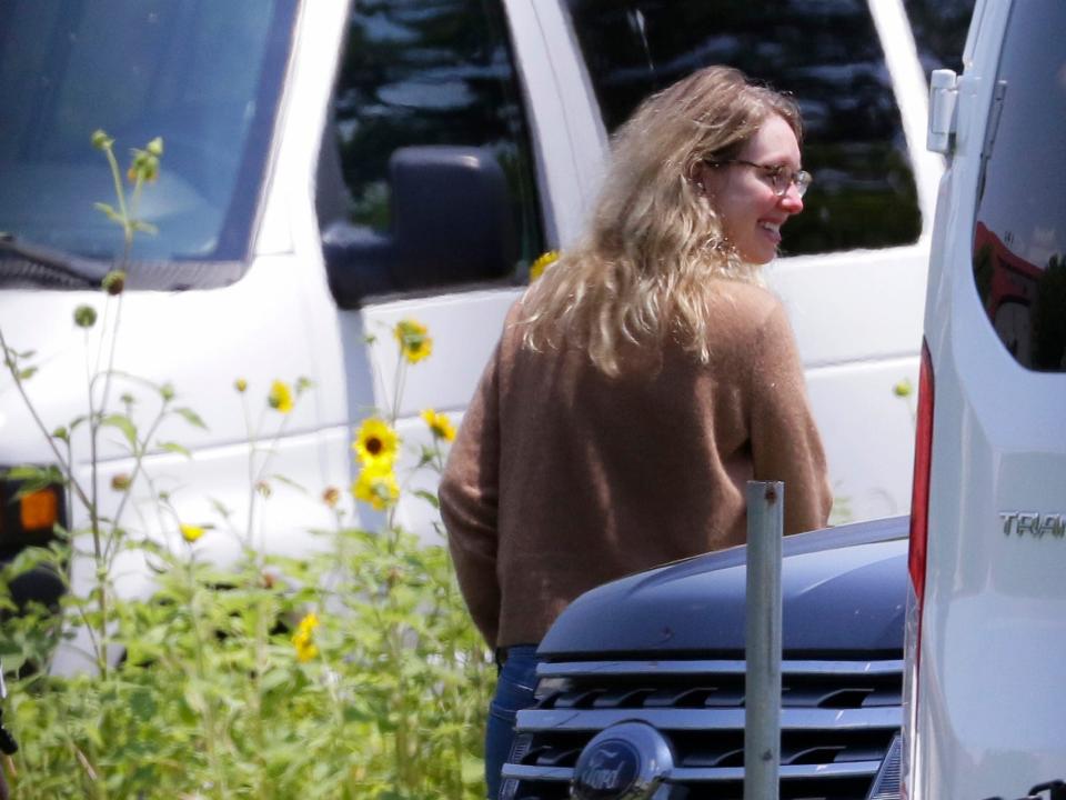 Disgraced Theranos CEO Elizabeth Holmes, right, is escorted by prison officials into a federal women’s prison camp on Tuesday, May 30, 2023, in Bryan, Texas. Holmes will spend the next 11 years serving her sentence for overseeing an infamous blood-testing hoax.