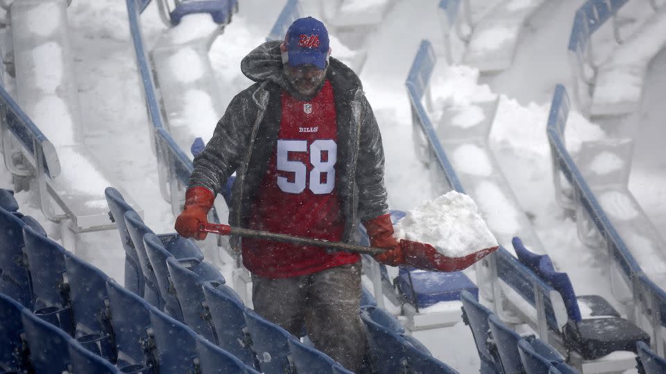 A worker helps remove snow from Highmark Stadium in Orchard Park, New York, on January 14. - Jeffrey T. Barnes/AP