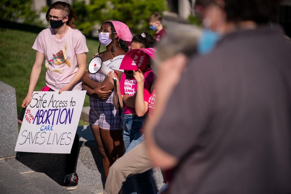 People listen to speakers during a demonstration at State Capitol in Nashville, Tenn., Monday, April 19, 2021. The gathering was in opposition to a bill requiring women who receive a surgical abortion to bury fetal remains.