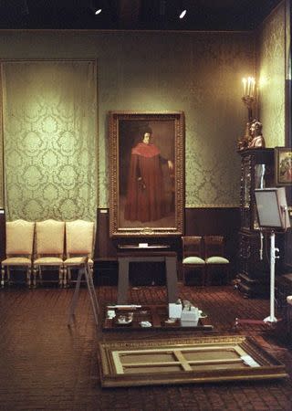 The empty frame of Rembrandt's oil painting "A Lady and Gentleman in Black" lies on the floor of the Isabella Stewart Gardner Museum in Boston, in this file photo taken March 21, 1990. REUTERS/Jim Bourg/Files