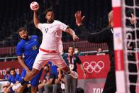 <p>France's left back Timothey NGuessan shoots during the men's Preliminary Round Group A handball match between Brazil and France of the Tokyo 2020 Olympic Games at the Yoyogi National Stadium in Tokyo on July 26, 2021. (Photo by Martin BERNETTI / AFP)</p> 