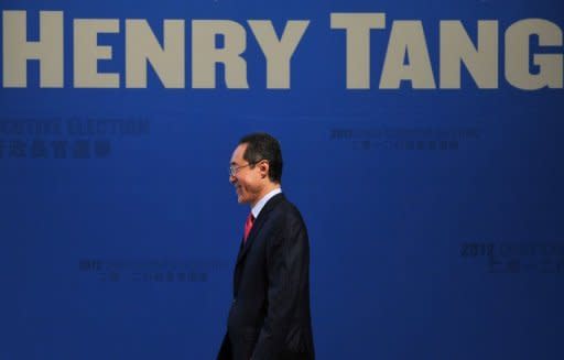 Hong Kong Chief Executive candidate and former Hong Kong Chief Secretary Henry Tang steps onto the stage at a campaign rally in Hong Kong in December 2011. Tang's campaign was in disarray Friday after he blamed his wife for an illegal wine cellar that was found in one of the wealthy couple's properties