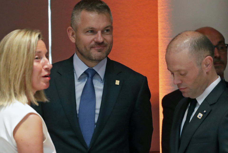 European Union foreign policy chief Federica Mogherini, left, speaks with Slovakian Prime Minister Peter Pellegrini, center, and Malta's Prime Minister Joseph Muscat during a round table meeting at an EU summit in Brussels, Sunday, June 30, 2019. European Union leaders have started another marathon session of talks desperately seeking a breakthrough in a diplomatic fight over who should be picked for a half dozen of jobs at the top of EU institutions. (Olivier Hoslet, Pool Photo via AP)