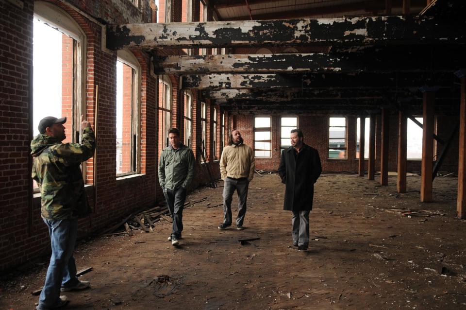 12/14/11 photo Ryan McFadden The Reading Outlet Center building 1 was bought by three members of the band Live and a developer who is their CEO. They give us a tour;  From left are CEO Bill Hynes, Live members  Chad Gracey, Patrick Dahlheimer and Chad Taylor (Photo By Ryan McFadden/MediaNews Group/Reading Eagle via Getty Images)