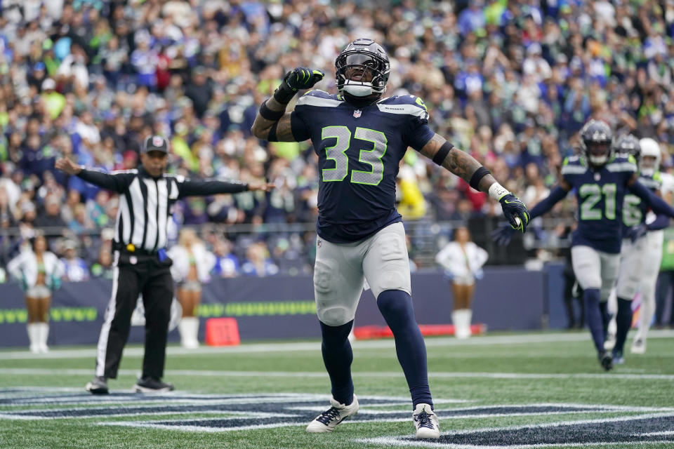 Seattle Seahawks safety Jamal Adams (33) celebrates a pass defense against the Seattle Seahawks as Seahawks cornerback Devon Witherspoon (21) looks on during the first half of an NFL football game Sunday, Oct. 22, 2023, in Seattle. (AP Photo/Lindsey Wasson)