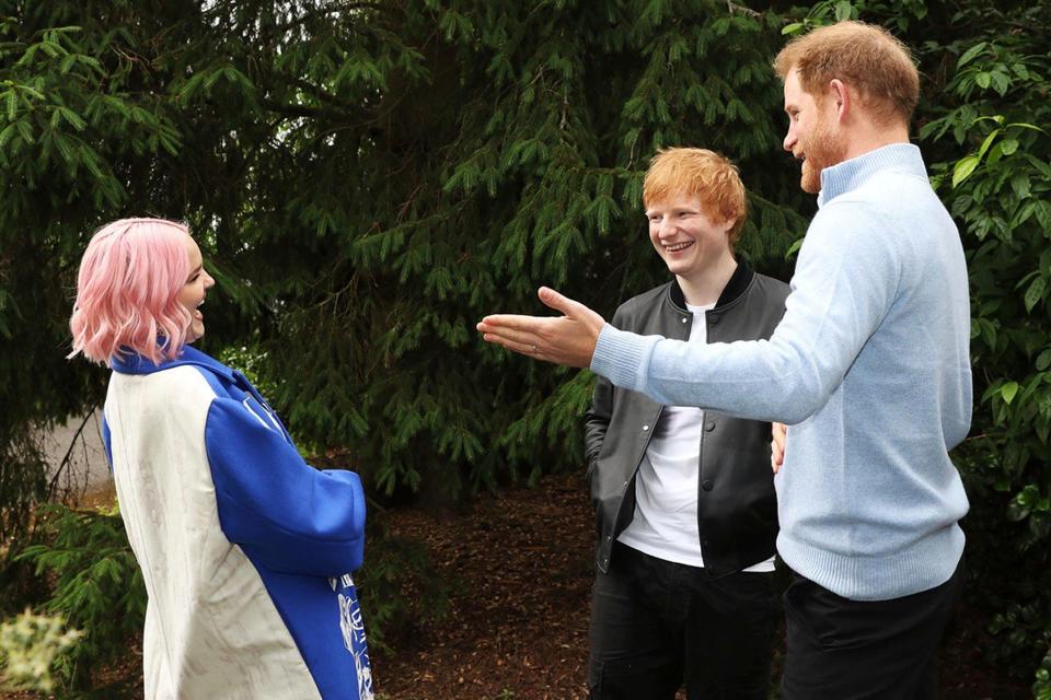 In this handout photo provided by Wellchild, Prince Harry speaks to singers Ed Sheeran and Anne-Marie during the WellChild Awards 2021 at a private garden party at Kew Gardens, in London, Wednesday June 30, 2021.