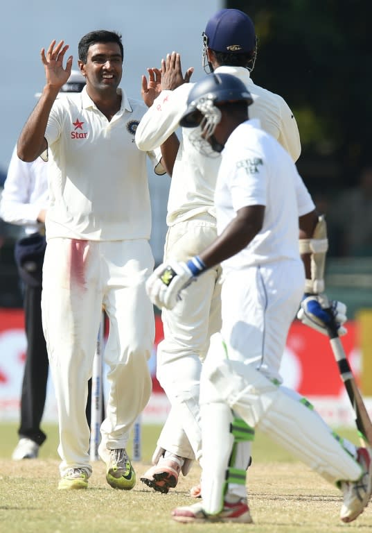 India's Ravichandran Ashwin (left) celebrates with teammates after dismissing Sri Lanka's Rangana Herath during the final day of the third Test in Colombo on September 1, 2015