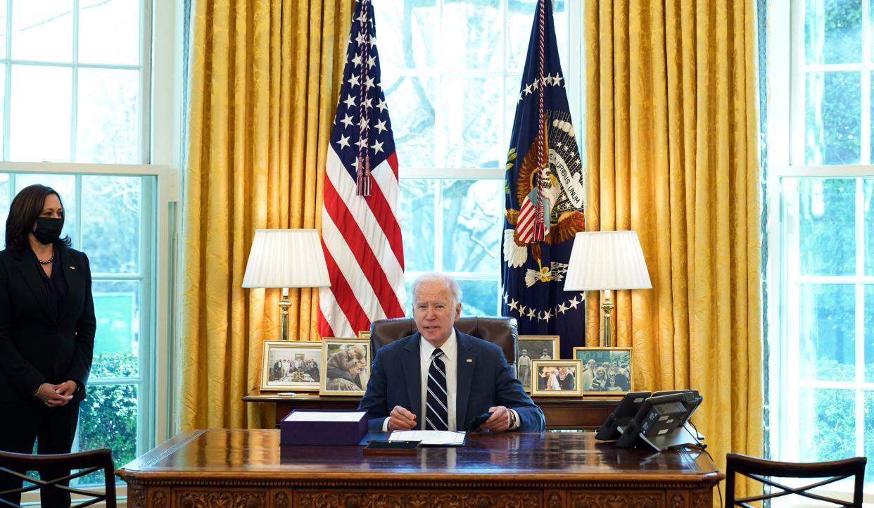 US President Joe Biden, with Vice President Kamala Harris, prepares to sign the American Rescue Plan on March 11, 2021, in the Oval Office of the White House in Washington, DC. - Biden signed the $1.9 trillion economic stimulus bill and will give a national address urging 